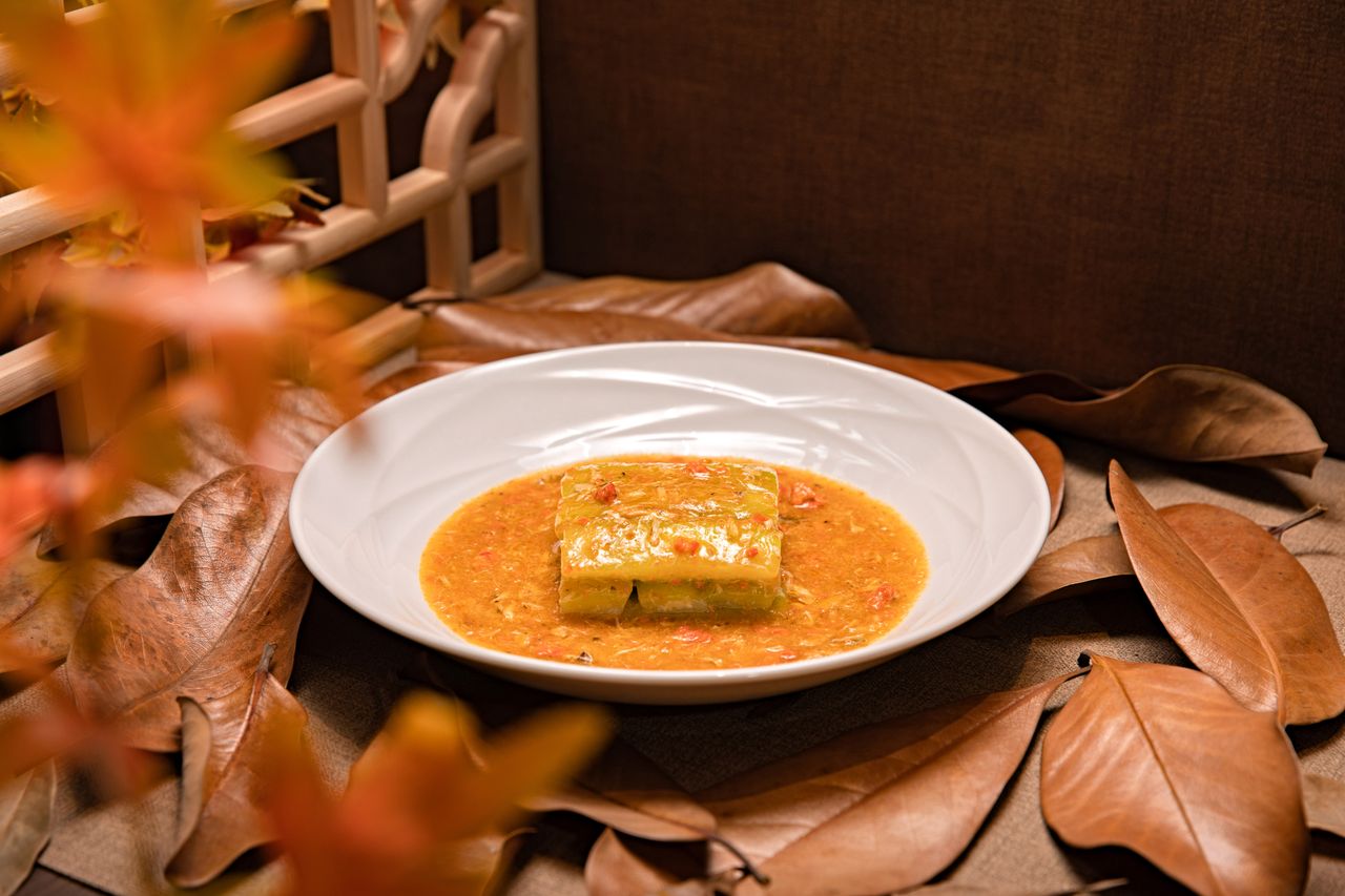 services-img A fusion dish garnished with autumn leaves in a rustic indoor setting, perfect for seasonal cuisine.